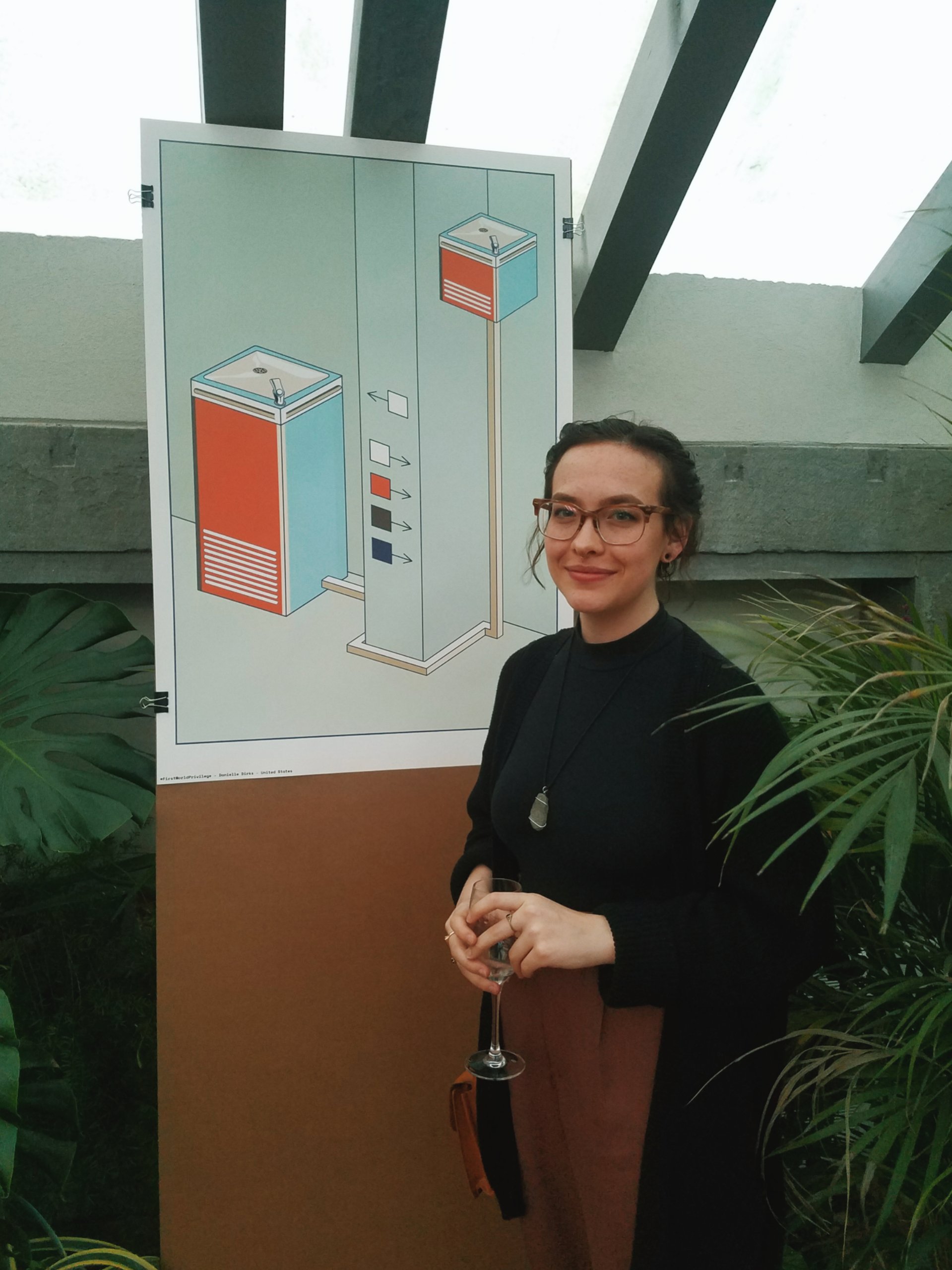Danielle Dirks with poster featured in the Shaping the Future exhibition in Italy.  